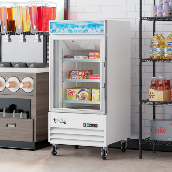 An Avantco white merchandiser refrigerator with glass doors full of drinks.