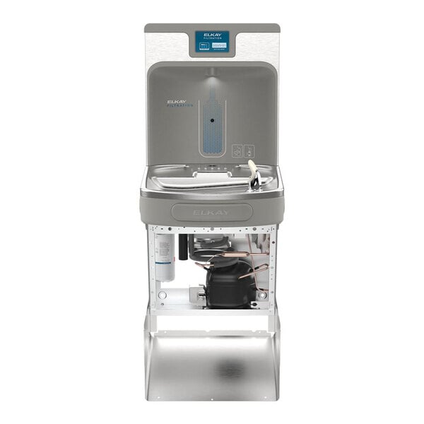 A stainless steel hands-free filtered bottle filling station with an integrated drinking fountain and visible internal components.
