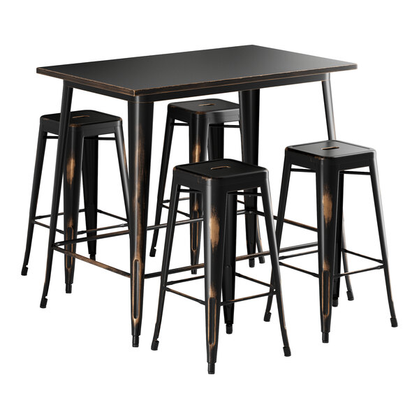 A Lancaster Table & Seating distressed copper bar height table with four black metal stools.