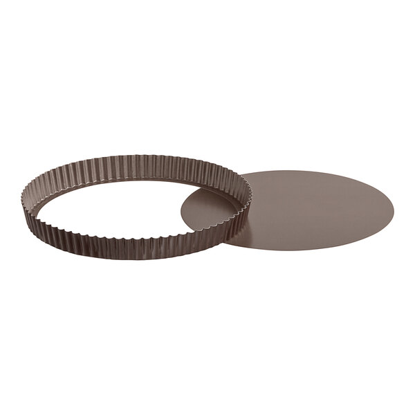 A Gobel round brown metal fluted tart pan with a circular ring on the bottom.