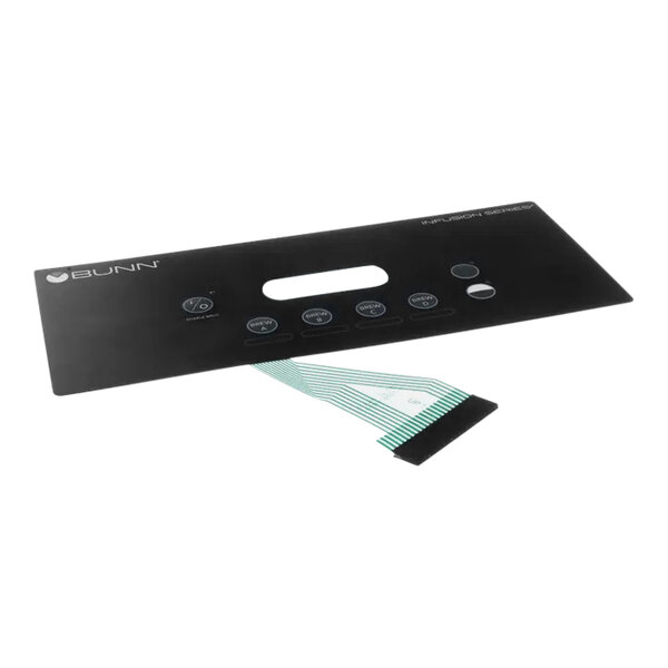 A black rectangular membrane switch with buttons and a green ribbon.