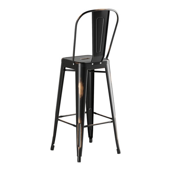 A black metal bar stool with a backrest at a Lancaster Table & Seating outdoor table.