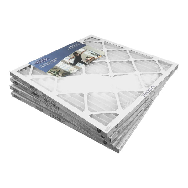 A stack of four Carrier air filters with white frames.