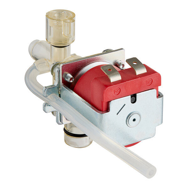 A close-up of a red and silver Bunn liquid valve with a tube.