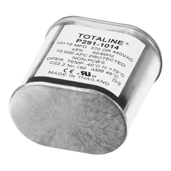 A silver Carrier oval run capacitor with a white label.