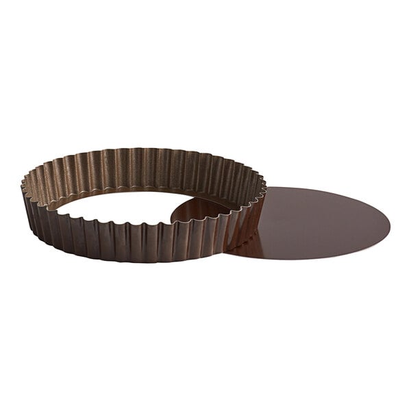 A brown round metal Gobel tart pan with a removable bottom.