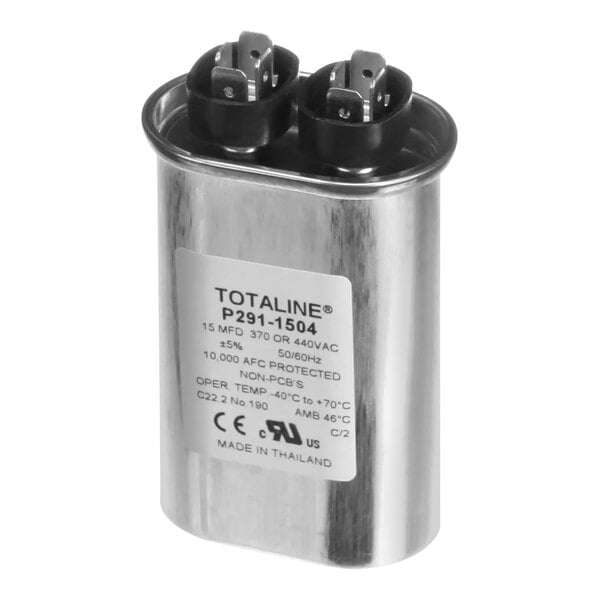 A close-up of a silver metal Carrier oval run capacitor with black electrical plugs.