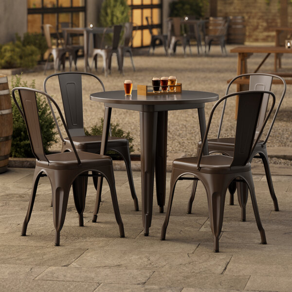 A Lancaster Table & Seating outdoor table with four chairs on a patio.