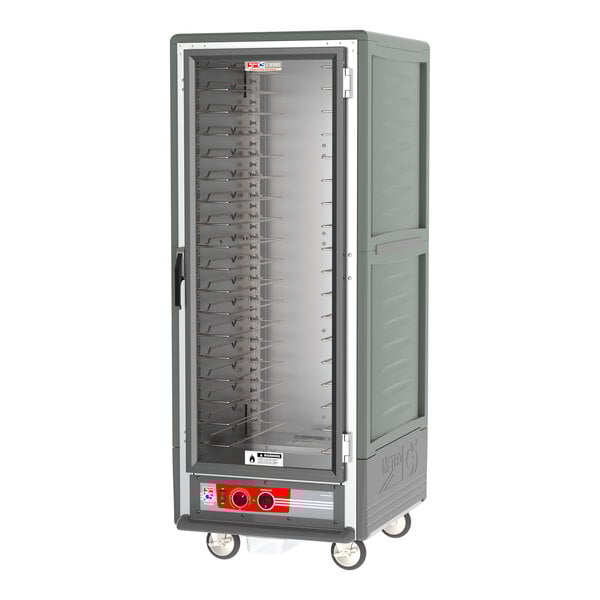 A large grey Metro C5 heated holding cabinet on wheels with shelves.