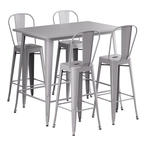 A Lancaster Table & Seating nickel gray outdoor table with four white cafe barstools.