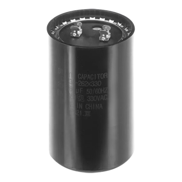 A close-up of a black circular Carrier start capacitor.