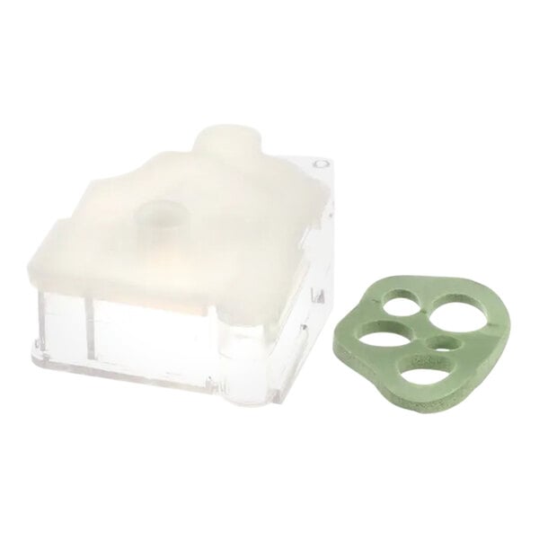 A clear plastic container with a green plastic ring and holes.