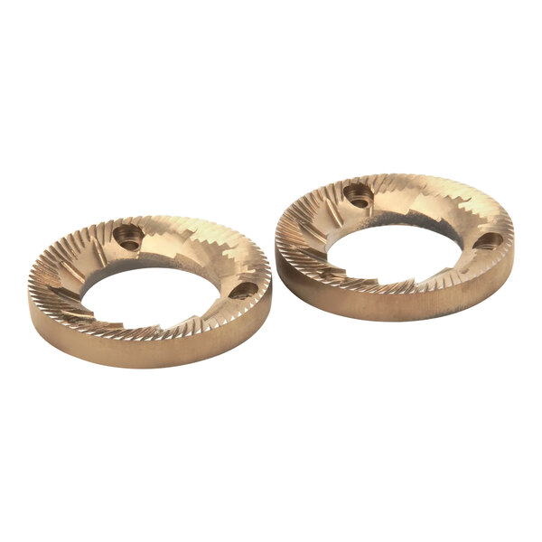 A pair of gold circular metal grinding discs with holes.