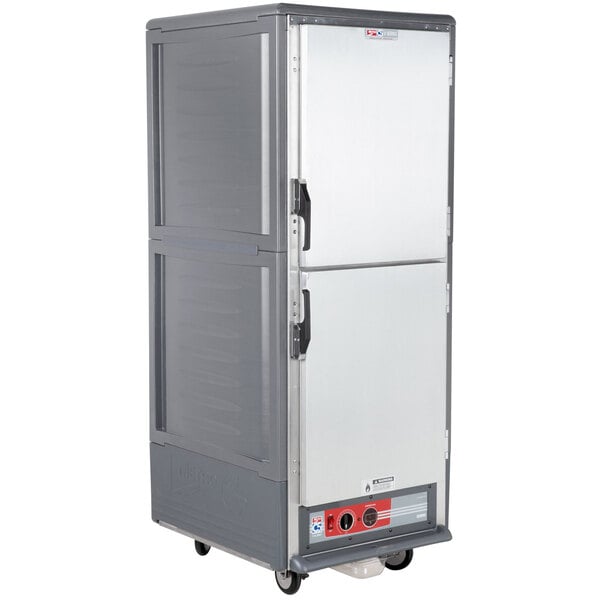 A gray Metro C5 heated holding cabinet with solid doors on wheels.