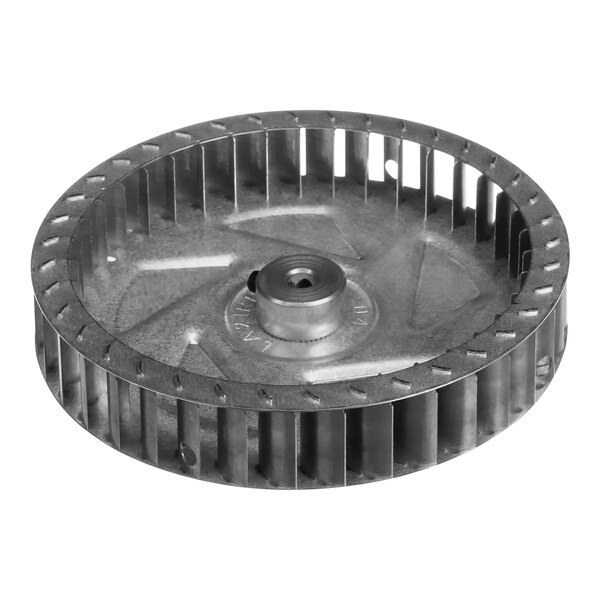 A metal circular blower wheel with a hole in the center.