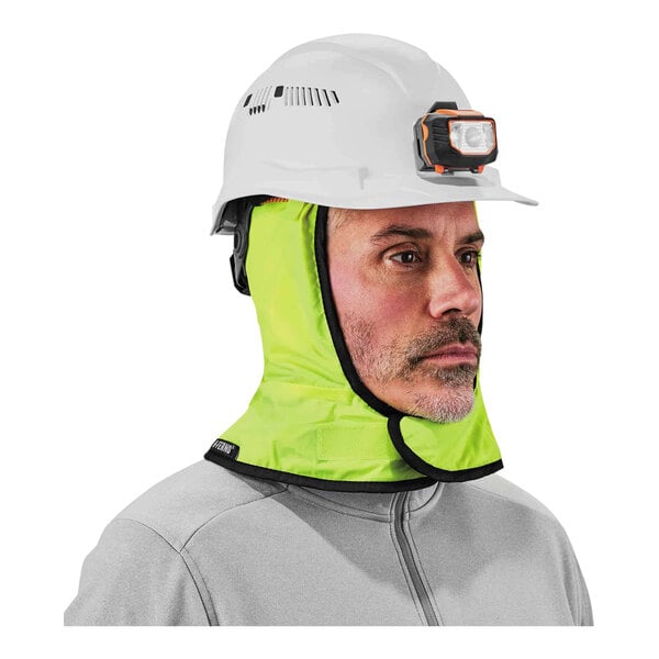 A man wearing an Ergodyne hi-vis lime green hard hat liner with a fleece lining under a hard hat.