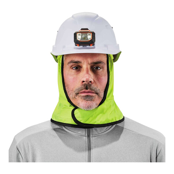 A man wearing an Ergodyne hi-vis lime green hard hat liner with a fleece lining.