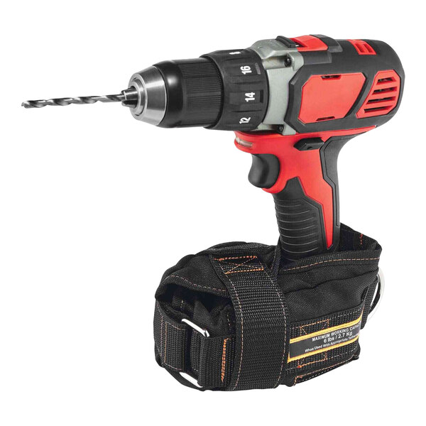 An Ergodyne Squids small black tool bag with orange stitching containing a corded drill with a black and red handle.