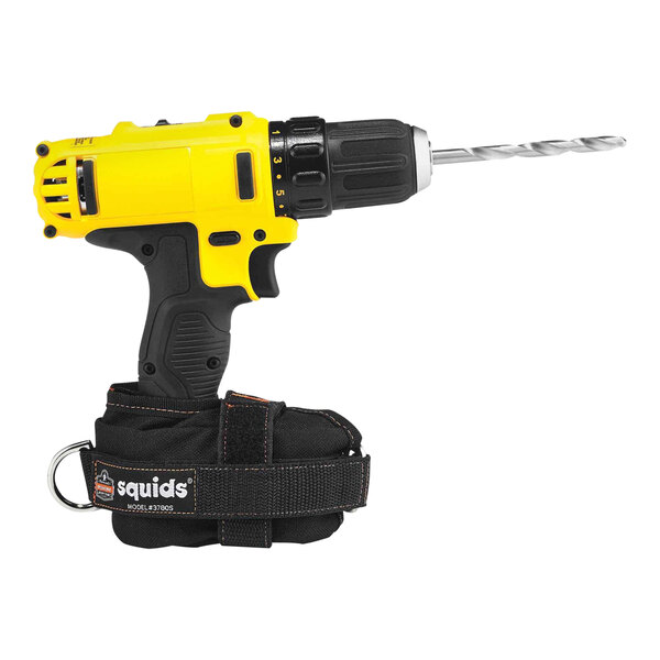 A yellow and black drill with a black strap attached to it using an Ergodyne Squids Small Power Tool Trap.