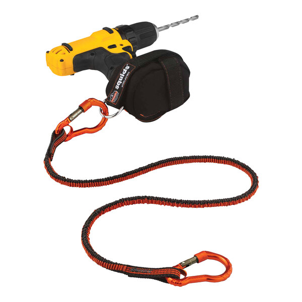 A yellow drill with a black strap attached to it using an Ergodyne Squids tool trap.