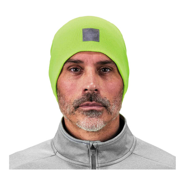 A man wearing a high visibility lime green rib knit beanie.
