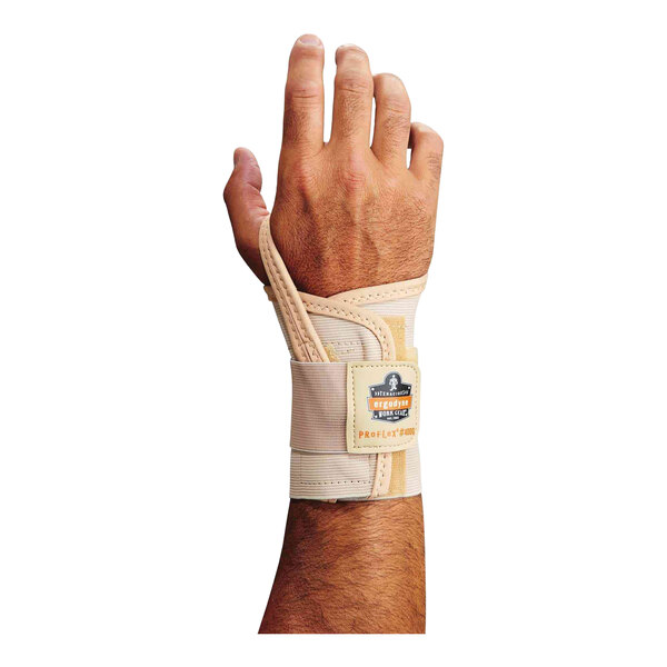 The left hand of a man wearing an Ergodyne ProFlex 4000 tan wrist support.