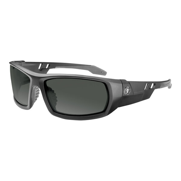 A close-up of Ergodyne Skullerz ODIN safety glasses with a matte black frame and grey lenses.