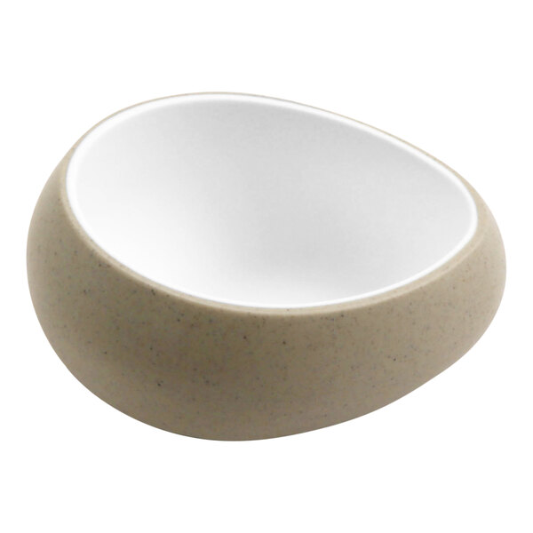 A white cheforward ramekin with a speckled surface.