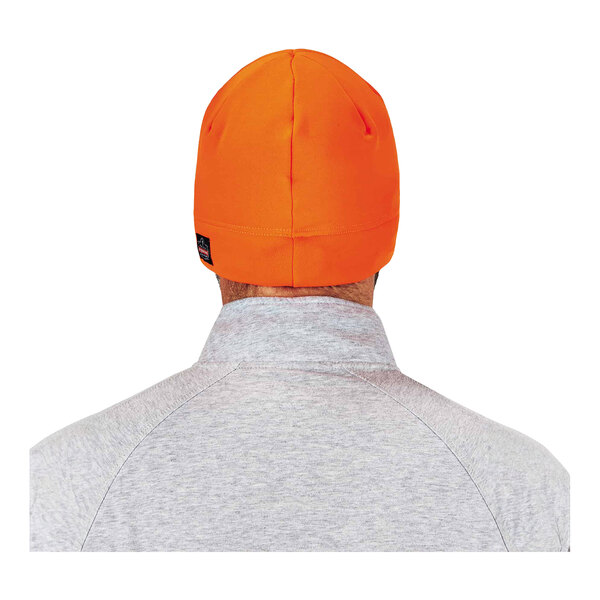 A man wearing an Ergodyne hi-vis orange skull cap with LED lights.
