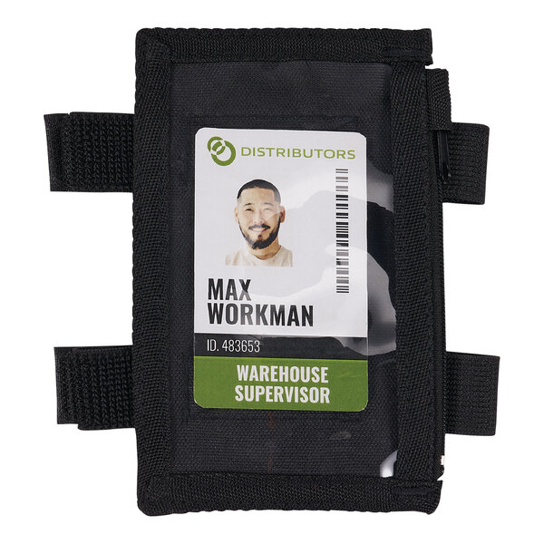 A man wearing an Ergodyne Squids black arm ID badge holder over his work shirt with his ID card in it.