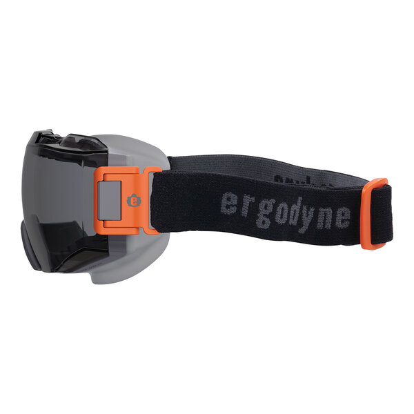 Ergodyne Skullerz MODI safety goggles with orange and black strap on a white background.