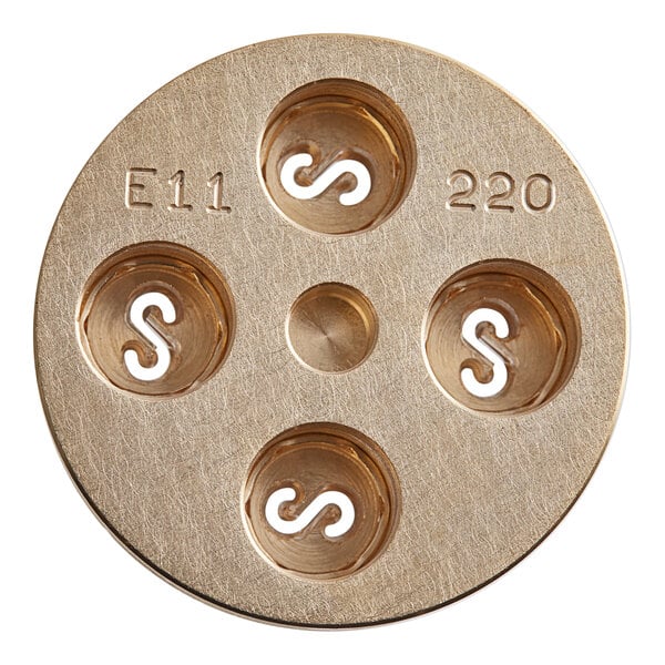 A circular brass Estella Casarecce pasta die with four holes.