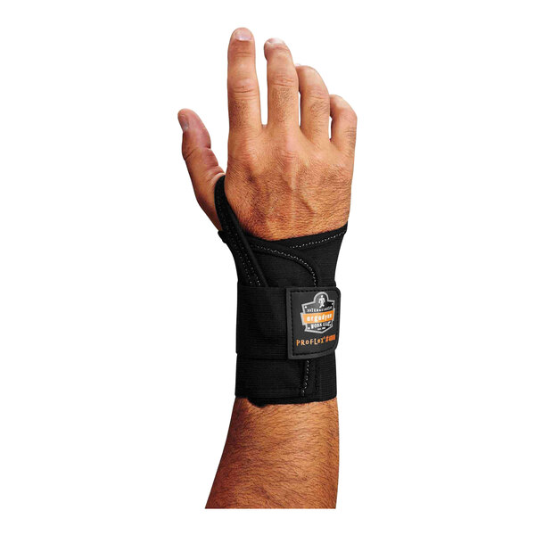 A man's right hand wearing a black Ergodyne ProFlex wrist brace.