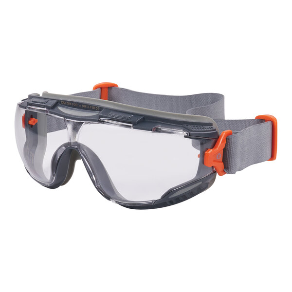 A close up of gray and orange Ergodyne Skullerz safety goggles with a neoprene strap.