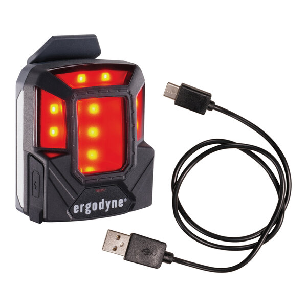 An Ergodyne Skullerz red headlamp with a USB cable attached.