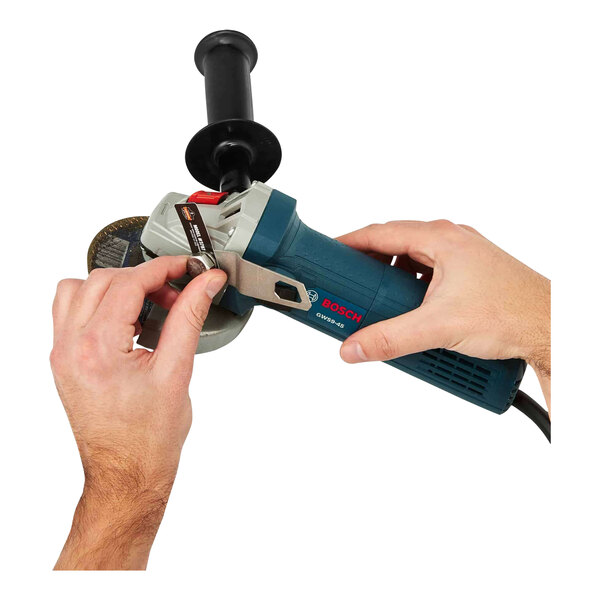 A hand holding an Ergodyne Squids tool tether kit.
