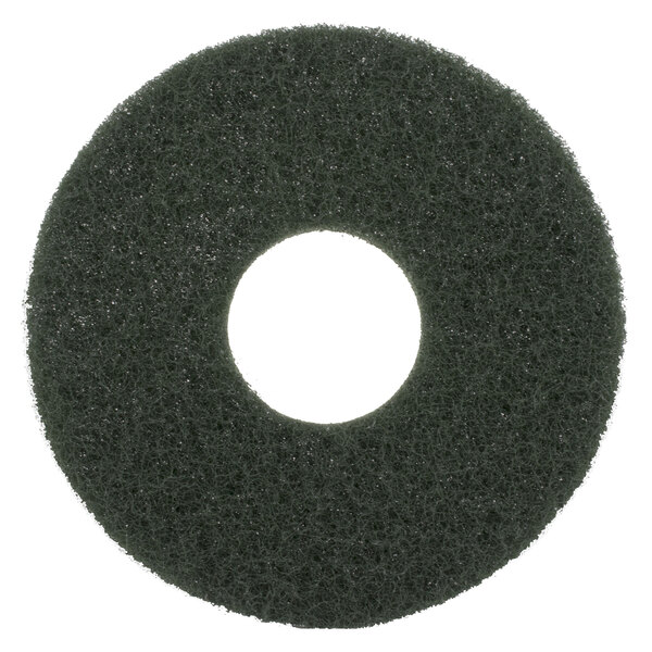 A black circular Scrubble floor pad with a green center and white circle.