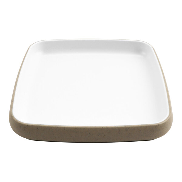 A white cheforward by GET square melamine plate with a tan rim.