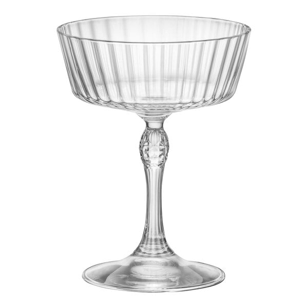 A clear glass Bormioli Rocco Fizz Cocktail Glass with a ruffled stem.
