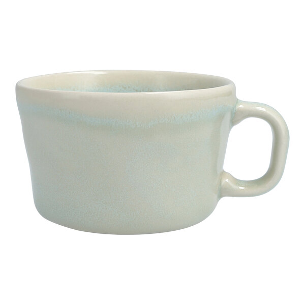 A white Cloud Terre by Fortessa espresso cup with a blue rim and speckled design.