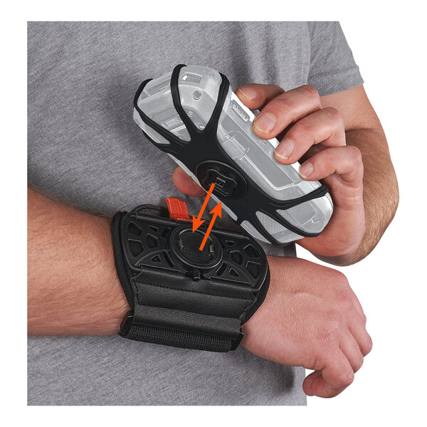 A person wearing a black Ergodyne wrist band with an orange strap holding a device.