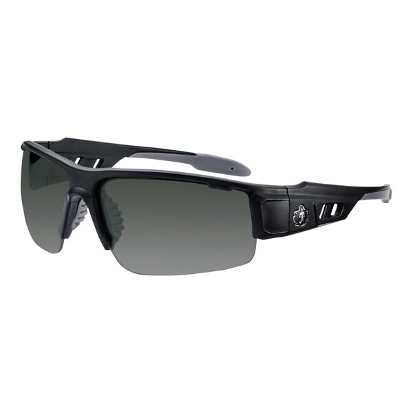 A close-up of Ergodyne Skullerz DAGR safety glasses with a matte black frame and smoke lenses.