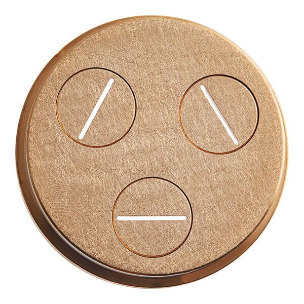 A circular brass object with circles and holes in it.