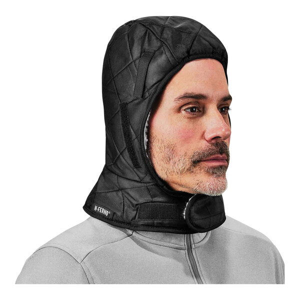 A man wearing a black Ergodyne hard hat liner with a hood.