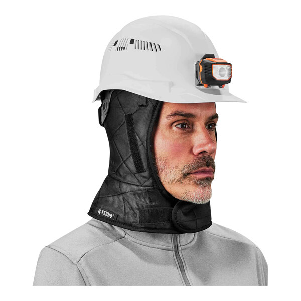 A man wearing a black Ergodyne winter hard hat liner with a neck warmer.