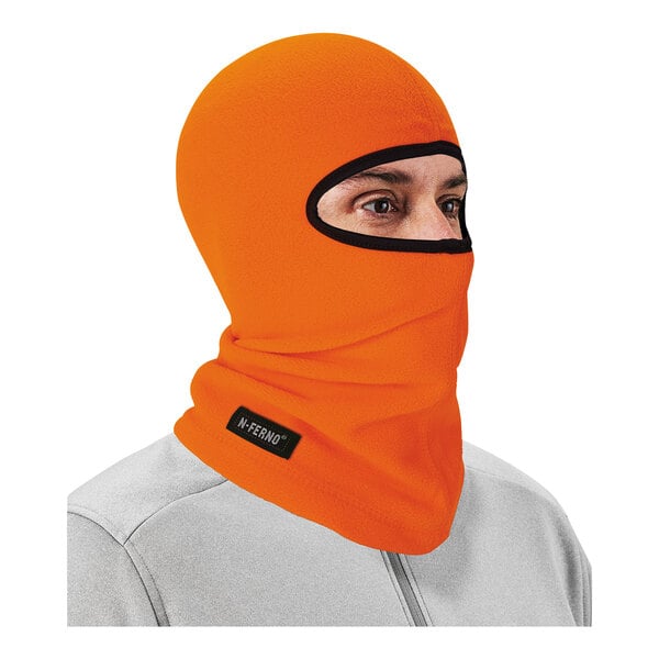 A person wearing a high visibility orange Ergodyne fleece balaclava face mask.