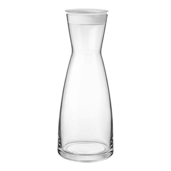 A clear glass carafe with a white lid.