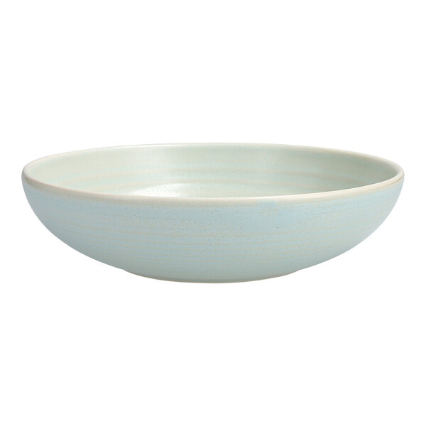 A white stoneware pasta bowl with a light blue rim.