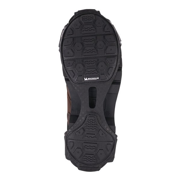 The sole of a black shoe with an Ergodyne TREX spikeless traction device.