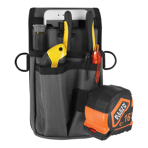An Ergodyne Arsenal tool pouch with a tape measure and tools in it.